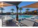 Community pool with shaded tables and lounge chairs at 9859 E Tungsten Dr, Mesa, AZ 85212