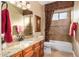 Clean bathroom with granite vanity, tub, and decorative tile at 10209 W Mustang Dr, Casa Grande, AZ 85194