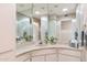 Bathroom with a corner sink and mirrored vanity at 10947 W Edgewood Dr, Sun City, AZ 85351