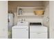 Laundry room with washer, dryer, and overhead shelving at 10947 W Edgewood Dr, Sun City, AZ 85351