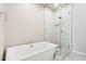 Modern bathroom with soaking tub, glass shower, and tiled floor at 14045 W Desert Flower Dr, Goodyear, AZ 85395