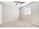 Empty bedroom featuring neutral-colored carpet, a ceiling fan, and a window at 14045 W Desert Flower Dr, Goodyear, AZ 85395