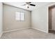 Empty bedroom with ceiling fan, window, and carpeted floor at 14045 W Desert Flower Dr, Goodyear, AZ 85395