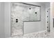 Modern bathroom showcasing a walk-in shower with marble tile and glass enclosure at 14790 W Tether Trl, Surprise, AZ 85387