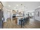 Spacious kitchen and dining area with wood-look tile flooring and modern finishes at 14790 W Tether Trl, Surprise, AZ 85387