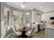 Bright kitchen with white cabinets, breakfast nook, and stainless steel appliances at 14988 N 100Th Way, Scottsdale, AZ 85260