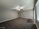 Living room with a ceiling fan, neutral gray walls, plush carpeting and French doors at 1640 E El Parque Dr, Tempe, AZ 85282