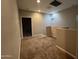 Carpeted hallway with doorway to another room and a half-wall at 1737 W Pollack St, Phoenix, AZ 85041