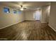 Living room with tile flooring, ceiling fan, and access to the backyard through a sliding glass door at 1737 W Pollack St, Phoenix, AZ 85041