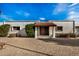 Charming single-story home with a terracotta tile roof, white stucco exterior, and desert landscaping at 2021 E Tierra Buena Ln # 11, Phoenix, AZ 85022