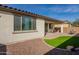 Exterior view of a house with a covered patio and landscaped backyard at 21013 W Almeria Rd, Buckeye, AZ 85396