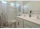 Clean bathroom boasts double sinks, white cabinets, and a shower/tub combo at 21013 W Almeria Rd, Buckeye, AZ 85396