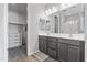 Bathroom with double sinks, walk-in shower, and a large closet at 22459 E Marsh Rd, Queen Creek, AZ 85142