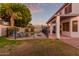 Backyard view of a two-story home with a pool, landscaping, and a fence at sunset at 2280 E Stephens Pl, Chandler, AZ 85225