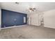 Large main bedroom with blue accent wall, ceiling fan, and a view of the ensuite bathroom at 2280 E Stephens Pl, Chandler, AZ 85225