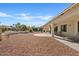 Covered patio with desert landscaping and a sitting area at 24407 S Starcrest Dr, Sun Lakes, AZ 85248