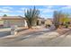 Charming single-story home with desert landscaping and attached two-car garage at 24407 S Starcrest Dr, Sun Lakes, AZ 85248