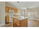 Kitchen features oak cabinets, white appliances, an island, and wood-look flooring at 24407 S Starcrest Dr, Sun Lakes, AZ 85248