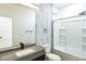 Modern bathroom with gray vanity and walk-in shower at 24825 W Western Star Blvd, Buckeye, AZ 85326
