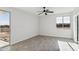 Bright bedroom with wood-look tile floors and access to a private patio at 24825 W Western Star Blvd, Buckeye, AZ 85326