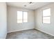 Bright bedroom with two windows and wood-look floors at 24825 W Western Star Blvd, Buckeye, AZ 85326