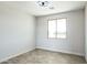 Well-lit bedroom with a window and ceiling fan at 24825 W Western Star Blvd, Buckeye, AZ 85326