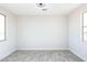 Spacious bedroom featuring wood-look floors and large windows at 24825 W Western Star Blvd, Buckeye, AZ 85326