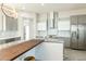 Modern kitchen with gray cabinetry, marble countertops, and a wood island at 24825 W Western Star Blvd, Buckeye, AZ 85326
