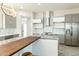 Modern kitchen with gray cabinetry, marble countertops, and a wood island at 24825 W Western Star Blvd, Buckeye, AZ 85326