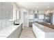 Modern kitchen with gray cabinets, marble countertops and a large sink at 24825 W Western Star Blvd, Buckeye, AZ 85326