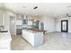 Open concept kitchen and living room with modern island and breakfast bar at 24825 W Western Star Blvd, Buckeye, AZ 85326