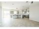Open concept kitchen and living area with modern design and tile floors at 24825 W Western Star Blvd, Buckeye, AZ 85326