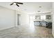 Open living room with tile flooring and access to the kitchen area at 24825 W Western Star Blvd, Buckeye, AZ 85326