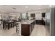 Open concept kitchen and dining area with island and dark wood cabinets at 268 S San Jose Ln, Casa Grande, AZ 85194