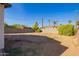 Backyard with dirt, block wall, and neighboring houses at 2906 W Palm Ln, Phoenix, AZ 85009