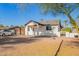 Inviting front yard with palm trees and a paved driveway leading to a single-story home at 2906 W Palm Ln, Phoenix, AZ 85009