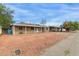 Front view of a single-story home with a covered porch and gravel landscaping at 2914 W Mackenzie Dr, Phoenix, AZ 85017