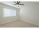 Cozy bedroom with ceiling fan, carpeted flooring, and large window at 3124 S 96Th St, Mesa, AZ 85212