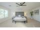 Spacious bedroom with plush carpet, windows, a ceiling fan, and modern decor at 3124 S 96Th St, Mesa, AZ 85212