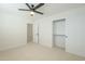 Spacious bedroom with ceiling fan, walk-in closet, and carpeted flooring at 3124 S 96Th St, Mesa, AZ 85212