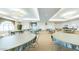 Large dining area with round tables, chairs, and decorative ceiling fixtures at 3301 S Goldfield Rd # 1046, Apache Junction, AZ 85119