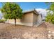 Exterior view of the home with a screened patio, trees, and landscaping at 3301 S Goldfield Rd # 1046, Apache Junction, AZ 85119