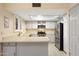 Kitchen featuring stainless steel appliances, white cabinetry, and tile flooring at 4303 E Cactus Rd # 146B, Phoenix, AZ 85032