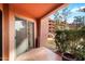Covered patio with tile flooring and sliding glass doors, overlooking the community pool at 4303 E Cactus Rd # 146B, Phoenix, AZ 85032