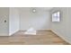 Bright, spacious bedroom with wood-look flooring, white walls, and a ceiling fan at 459 E Hampton Ave, Mesa, AZ 85204