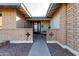 The entry walkway leads to a black front door, nestled between brick walls at 607 E Manhatton Dr, Tempe, AZ 85282