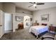 Bedroom with carpeted flooring, ceiling fan, and an ensuite bathroom access at 6180 N 88Th Ln, Glendale, AZ 85305