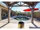 Covered patio overlooking a serene pool, perfect for outdoor entertaining at 6180 N 88Th Ln, Glendale, AZ 85305