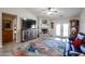 Inviting living room with a fireplace, ceiling fan, and access to the backyard at 6180 N 88Th Ln, Glendale, AZ 85305