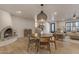 Light-filled living and dining area featuring a stone fireplace and hardwood floors at 6439 E Presidio Rd, Scottsdale, AZ 85254